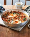 spicy-baked-eggs-with-tomatoes-and-chickpeas-recipe-delicious image