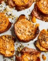 cheesy-garlic-and-herb-smashed-sweet-potatoes-kitchn image