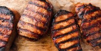 best-grilled-pork-chops-recipe-how-to-grill-pork-chops-delish image