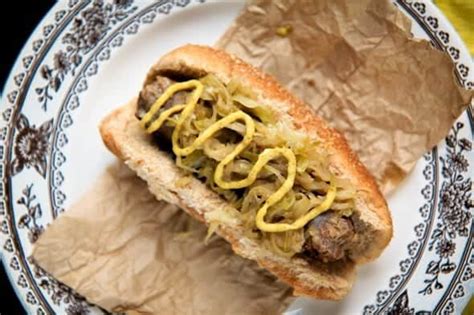 beer-braised-brats-with-quick-apple-and-onion-sauerkraut image