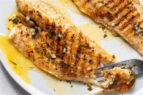 grilled-sea-bass-with-garlic-butter-recipe-the-spruce image