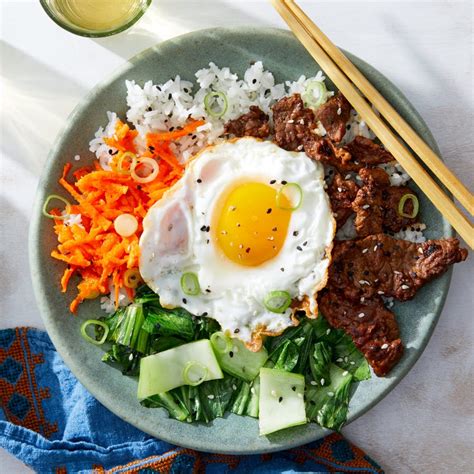 korean-beef-rice-bowls-with-vegetables-fried-eggs image