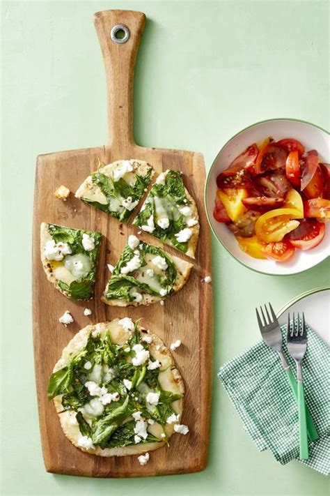spinach-and-cheese-pita-pizzas-with-tomato-salad image