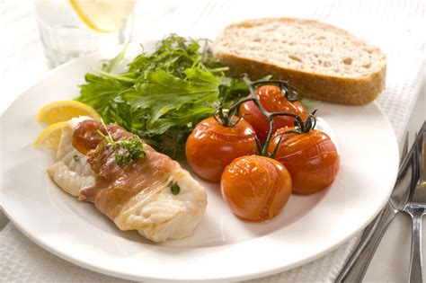 prosciutto-wrapped-fish-with-roasted-vine-tomatoes image
