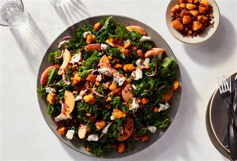 kale-salad-with-peaches-and-cornbread-croutons image