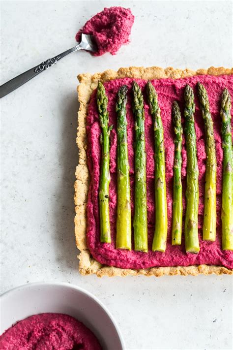 beet-hummus-asparagus-tart-with-almond-crust-crumb image