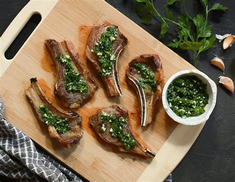 lamb-popsicles-drizzled-in-garlic-parsley-sauce-paleo image