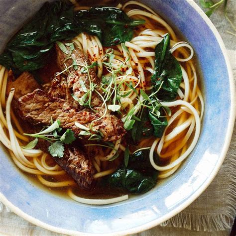 garlic-ginger-beef-noodle-soup-spoon-fork-bacon image