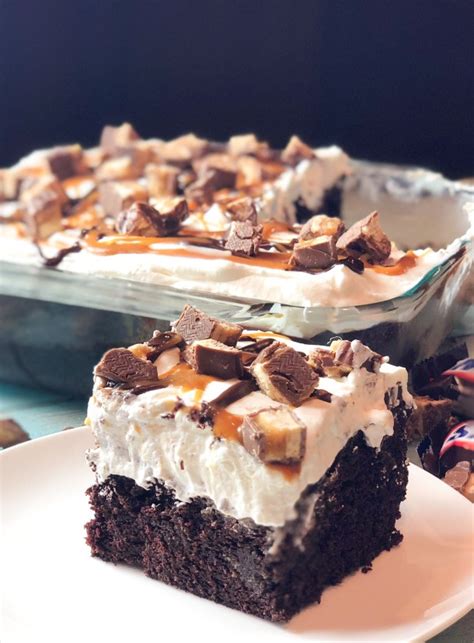 snickers-poke-cake-with-caramel-and-chocolate-sauce image
