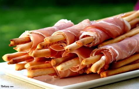 cheesy-prosciutto-wrapped-breadsticks image