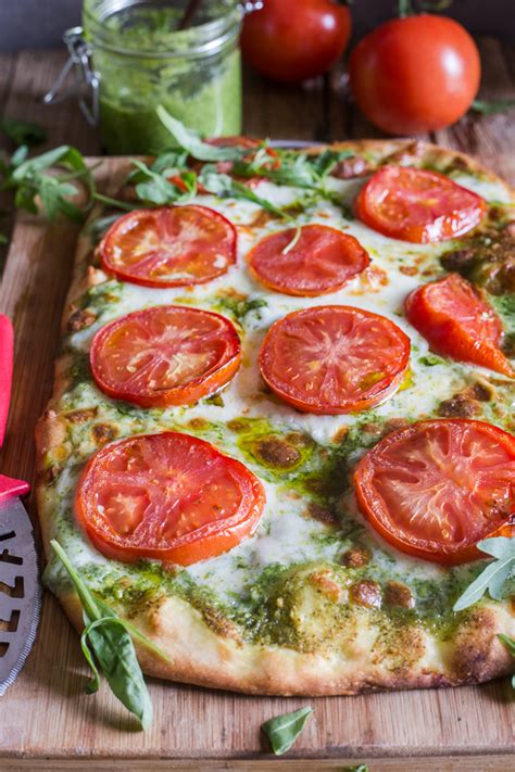 pesto-pizza-with-fresh-tomatoes-mozzarella-an image