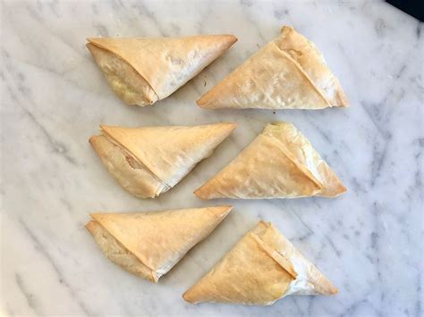 phyllo-cheese-triangles-recipe-tiropita-the-spruce image