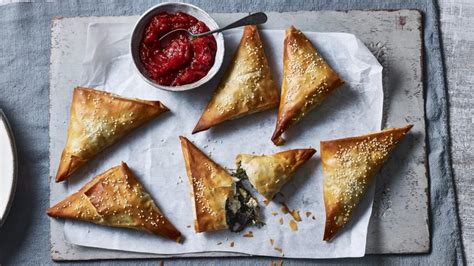 feta-and-greens-filo-triangles-recipe-bbc-food image