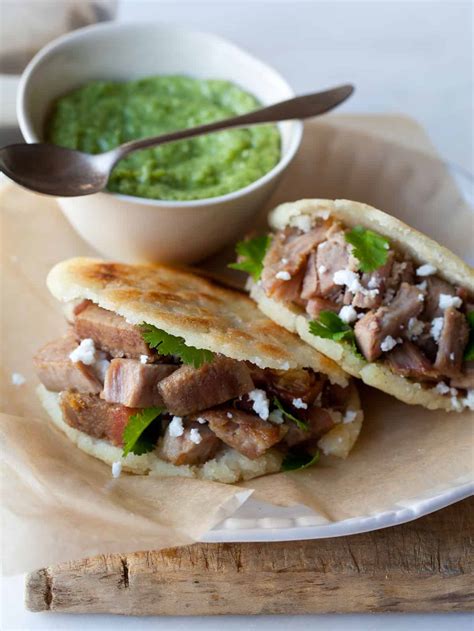 arepas-filled-with-carnitas-and-guasacaca-spoon-fork image