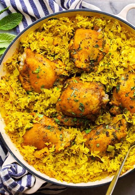 herby-golden-baked-chicken-and-rice-a-saucy-kitchen image