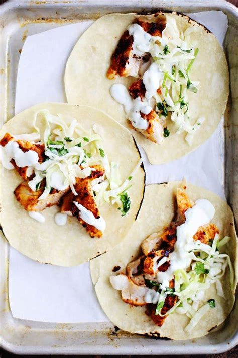 spicy-fish-tacos-with-cabbage-slaw-lime-crema image