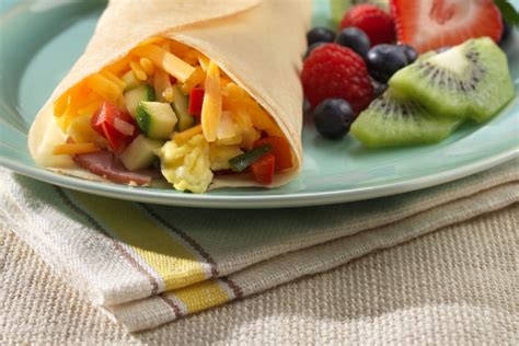 stuffed-crepes-with-eggs-cheddar-ham-and-veggies image