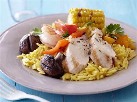 grilled-meats-and-vegetables-over-saffron-orzo image