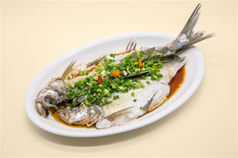 chinese-whole-steamed-fish-recipe-the-spruce-eats image