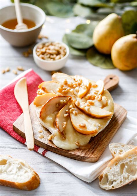 caramelized-pear-and-walnut-topped-brie-with-honey image