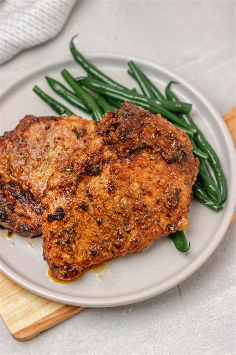 easy-oven-baked-pork-chops-recipe-the-dinner-bite image