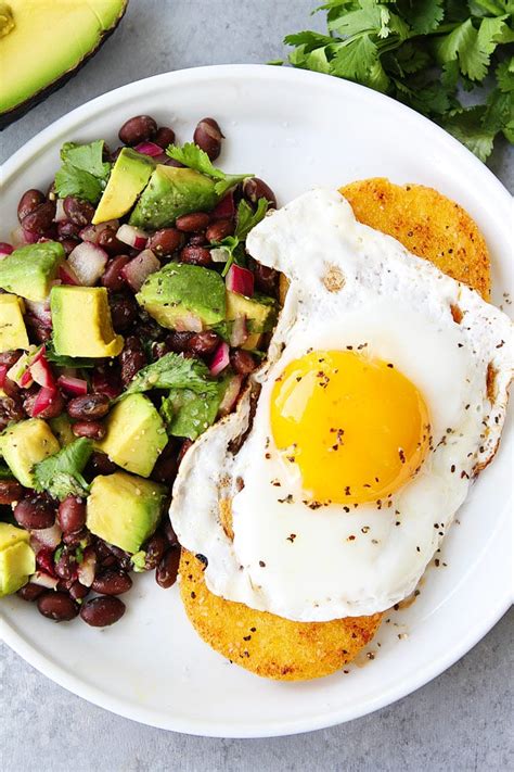 polenta-rounds-with-fried-eggs-and-avocado-bean-salsa image