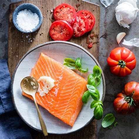 grilled-salmon-with-tomatoes-basil-eatingwell image