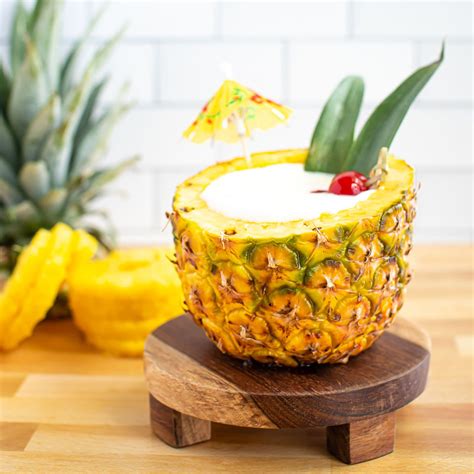 pia-colada-in-a-pineapple-eatingwell image