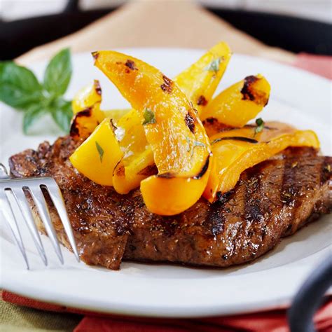 peppered-ribeye-steaks-with-grilled-sweet-peppers image