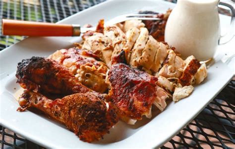 beer-can-chicken-with-white-barbecue-sauce-edible image