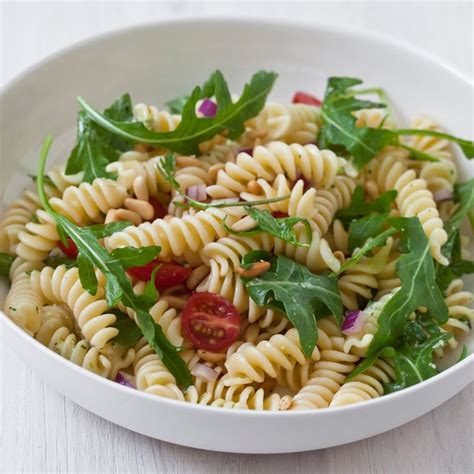 pasta-salad-with-tomatoes-arugula-pine-nuts-and-herb image