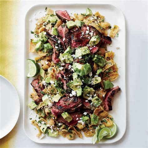 cola-marinated-flank-steak-with-frito-chilaquiles-food image