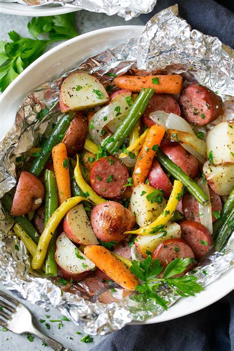 garlic-herb-sausage-and-veggie-foil-packs-cooking image