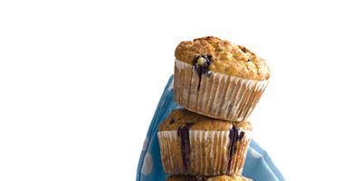 banana-blueberry-cornmeal-muffins-recipe-delish image