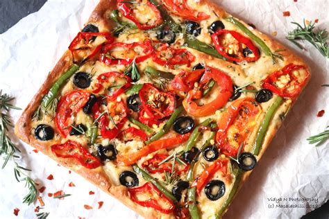 whole-wheat-focaccia-with-peppers-tomatoes-olives image