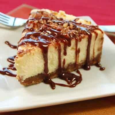 praline-cheesecake-with-hot-fudge-caramel-sauce image