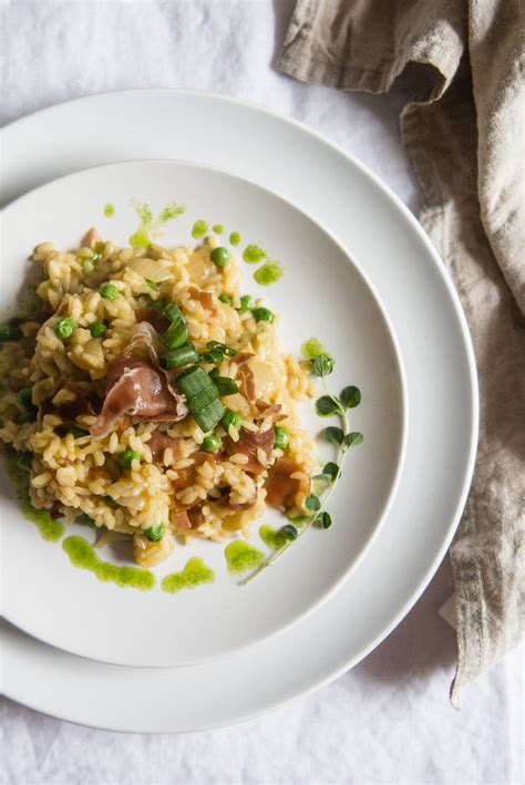 risotto-with-peas-crispy-prosciutto-two-red-bowls image