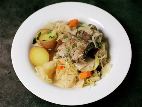 andrew-zimmern-cooks-pork-ribs-with-sauerkraut image