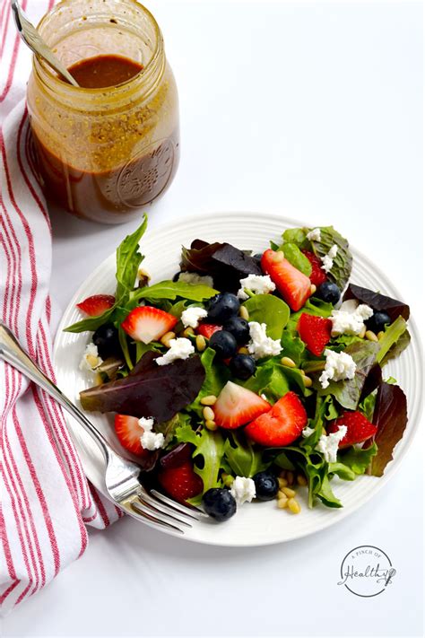 summer-salad-with-berries-goat-cheese-and-pine-nuts image