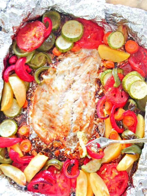 baked-fish-in-foil-with-vegetables-garlic-lemon-juice image
