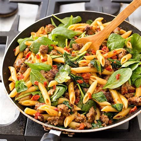 skillet-penne-with-sausage-and-spinach-cooks image