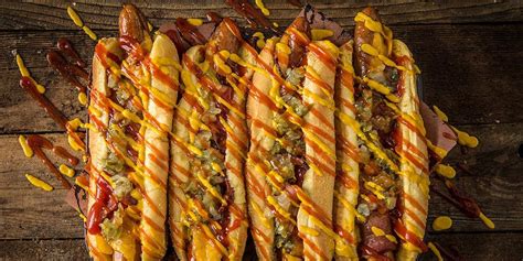 grilled-bacon-wrapped-hot-dogs-recipe-traeger-grills image