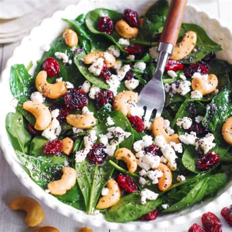 cranberry-spinach-salad-with-cashews-and-goat-cheese image