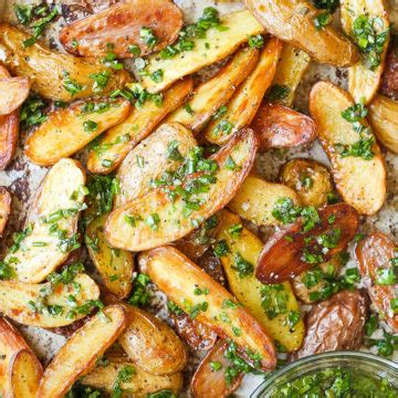baked-garlic-herb-potato-wedges-damn-delicious image