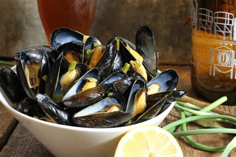 beer-steamed-mussels-with-garlic-scapes-lemon image