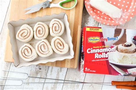 campfire-cinnamon-rolls-on-a-stick-over-a-fire-or-grill image
