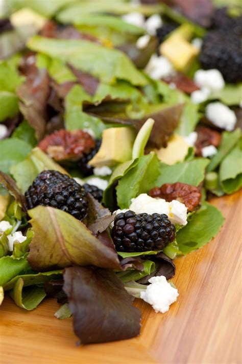 greens-with-blackberries-and-passionfruit-vinaigrette image