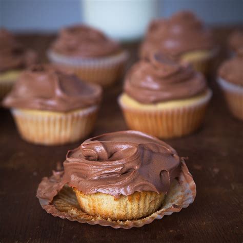 vanilla-bean-golden-cupcakes-with-chocolate-frosting image