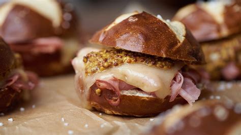 baked-ham-and-swiss-cheese-sliders-recipe-tasting-table image