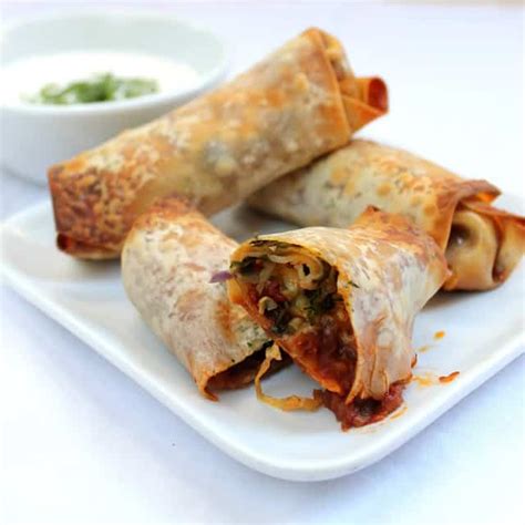 baked-mexican-egg-rolls-with-cilantro-lime-crema image